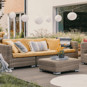 outdoor living space with couch, side table and hanging lights